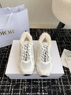 Dior unisex sneakers in white with lace-up design and plush shearling lining.