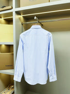 Light blue striped Burberry button-up shirt, back view