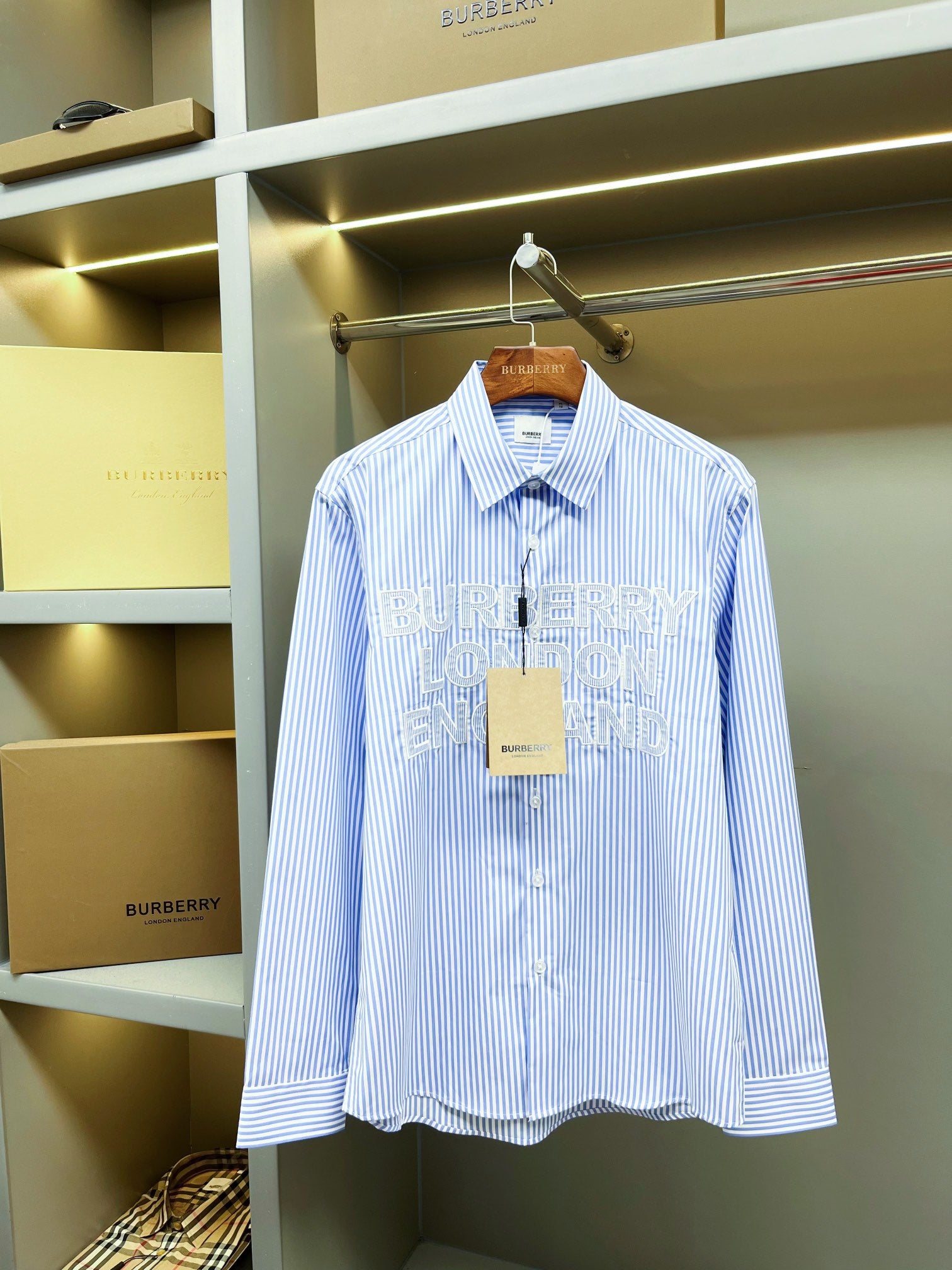 Light blue striped Burberry button-up shirt, pointed collar, front buttons