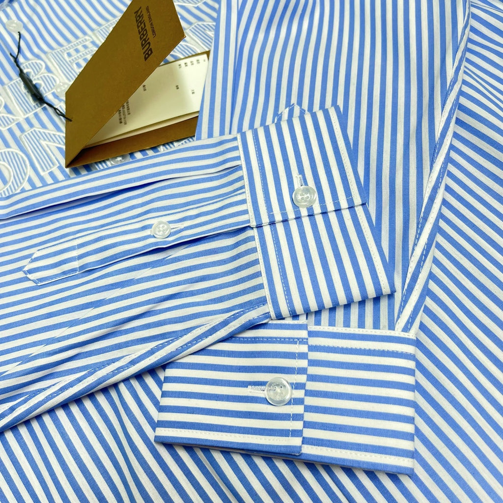 Light blue striped Burberry button-up shirt cuffs with round buttons