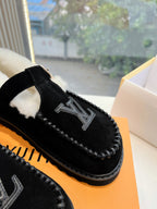Close-up of black Louis Vuitton loafer upper with LV emblem and stitched edge