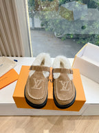 Louis Vuitton tan suede shearling mules with buckled straps and LV front logos