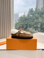 Louis Vuitton tan suede shearling mules with buckled strap and black sole edge
