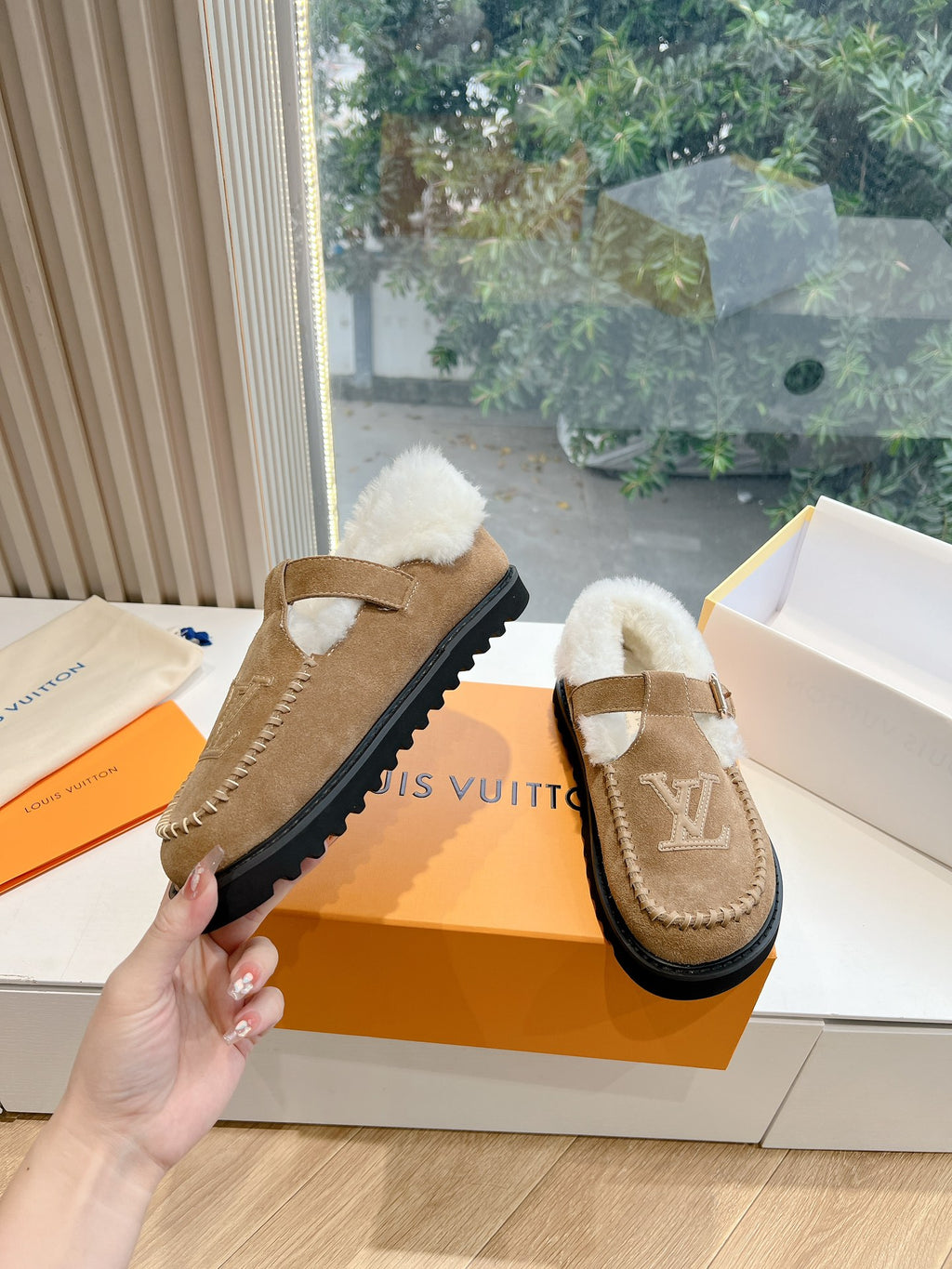 Louis Vuitton tan suede shearling mules with buckled strap and LV side logo