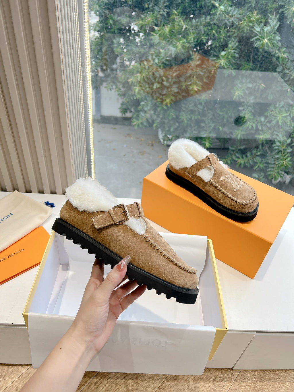 Louis Vuitton tan suede shearling mule with buckled strap, thick rubber sole