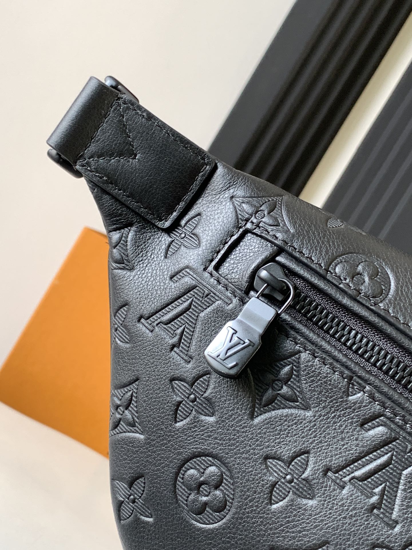 Louis Vuitton monogram crossbody bag close-up of front flap and zipper pull