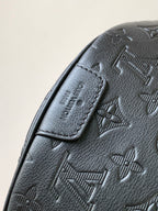 Louis Vuitton monogram crossbody bag close-up of stitched leather strap tab