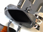 Dark monogram zip-top bag with open top and black fabric interior