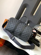 Dark monogram duffel bag with top handles and wide shoulder strap