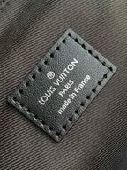 Leather brand tag on handbag with stitched border and text 'made in France'