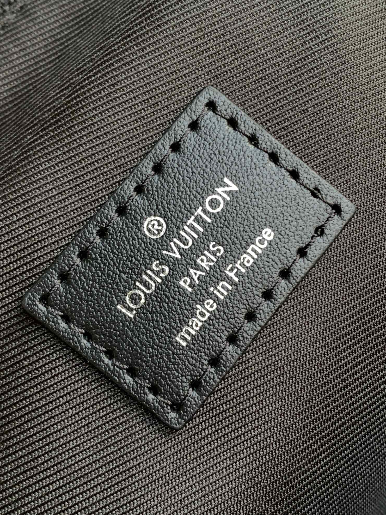 Leather brand tag on handbag with stitched border and text 'made in France'