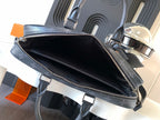 Handbag open top with black interior, dark monogram trim, and zipper closure