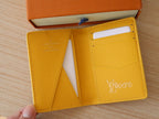 Yellow Louis Vuitton monogram small wallet/card holder with card slots visible