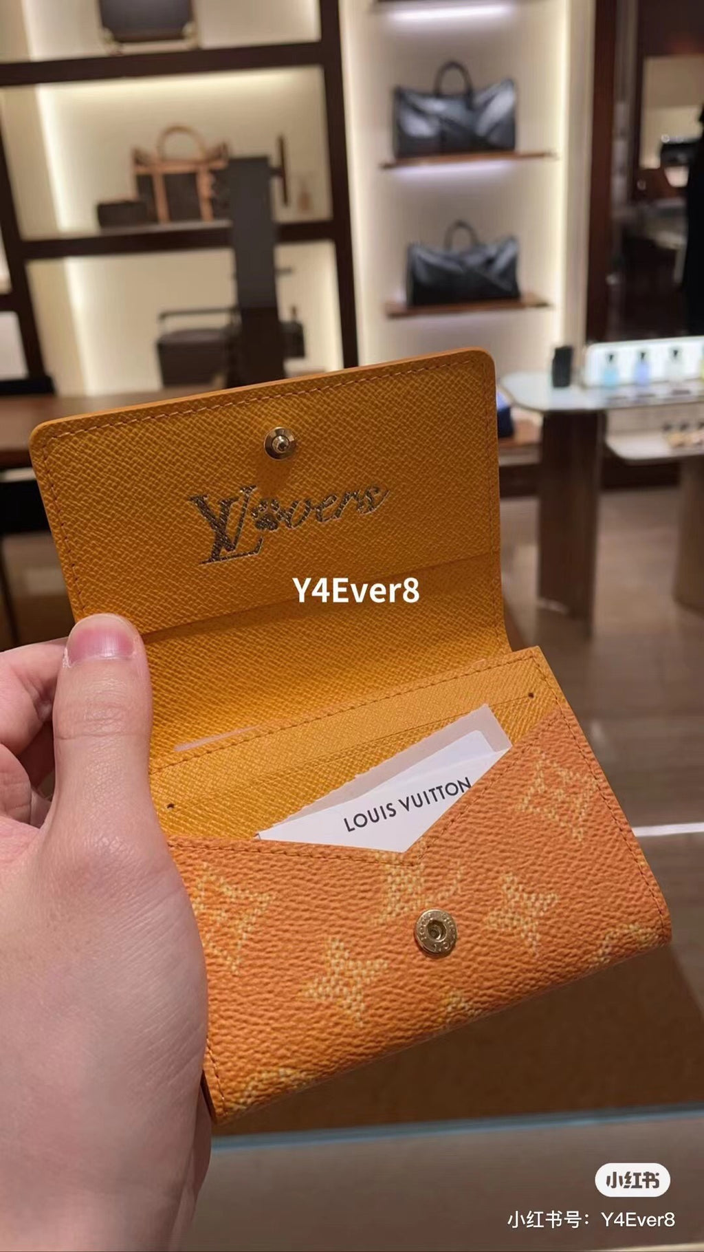 Louis Vuitton small wallet with flap, orange monogram fabric and snap closure