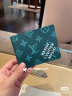 Louis Vuitton small wallet, dark green monogram print with white logo text on flap