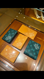 Small Louis Vuitton monogram small bag set: teal and orange pouches on display