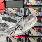 Grey lace-up sneakers with purple side stripe, textured sole and heel detail