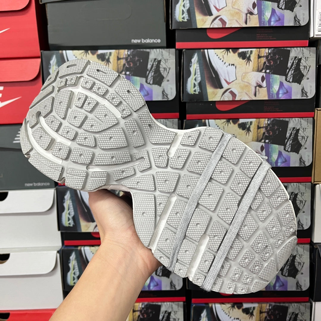 Grey sneaker outsole with grid tread pattern, underside view