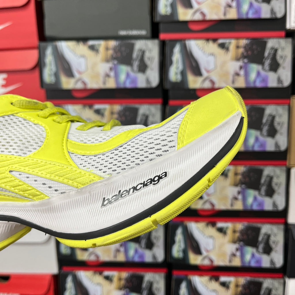 Neon yellow and white side profile lace-up running shoe with logo on midsole