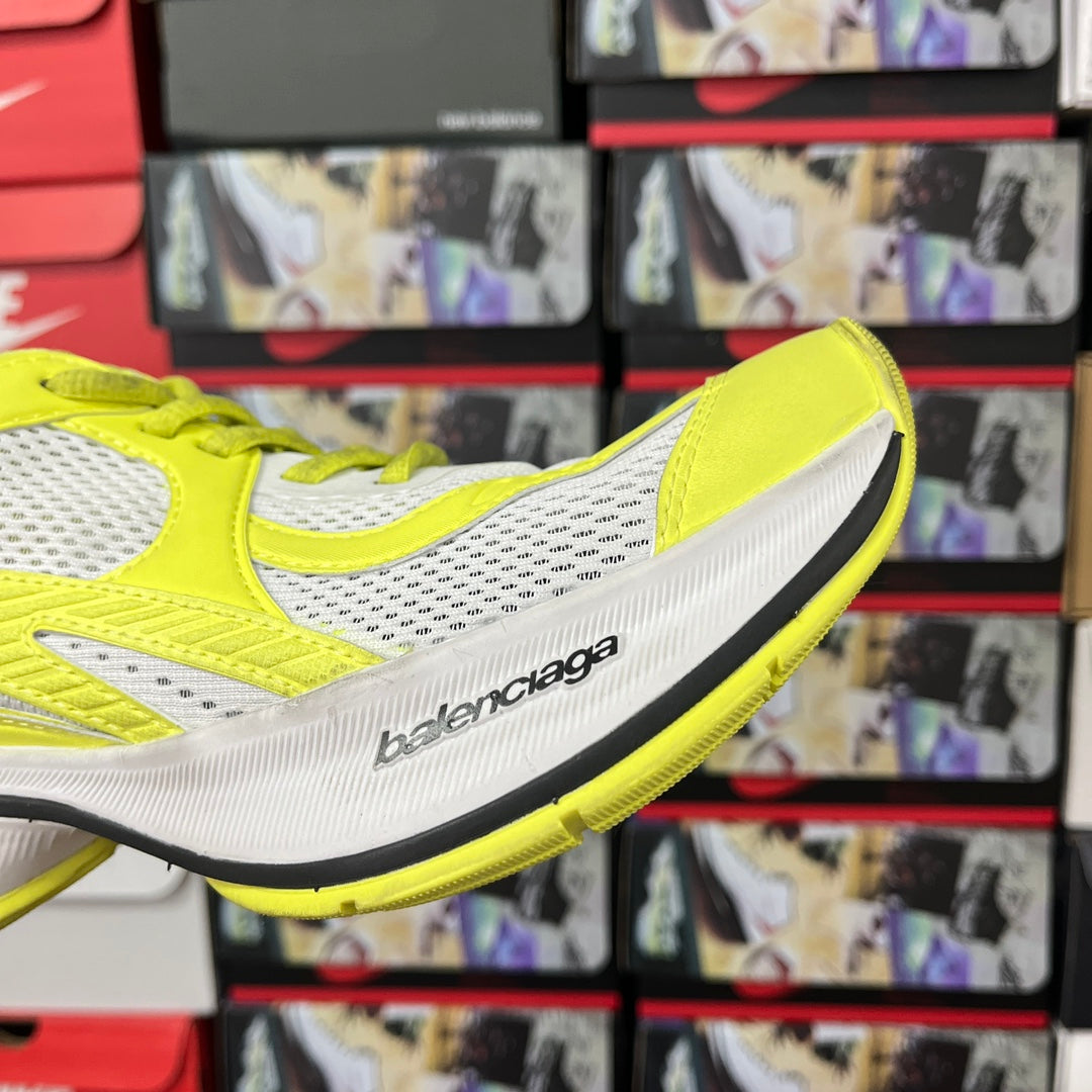 Neon yellow and white side profile lace-up running shoe with logo on midsole