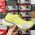 Neon yellow and white lace-up running shoes with mesh panels and black trim