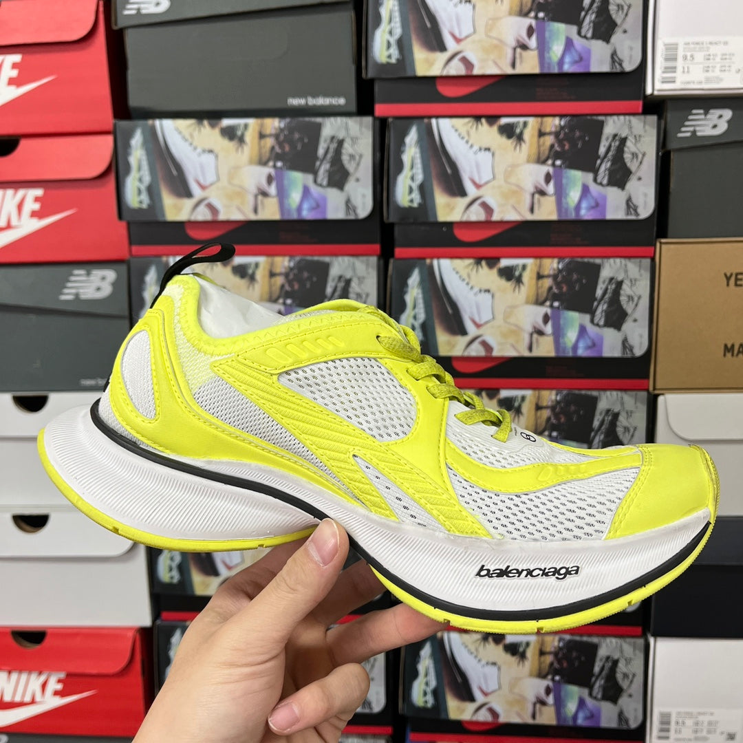 Neon yellow and white lace-up running shoes with mesh panels and black trim