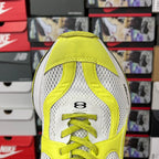 Neon yellow and white lace-up running shoe with perforated toe and logo patch