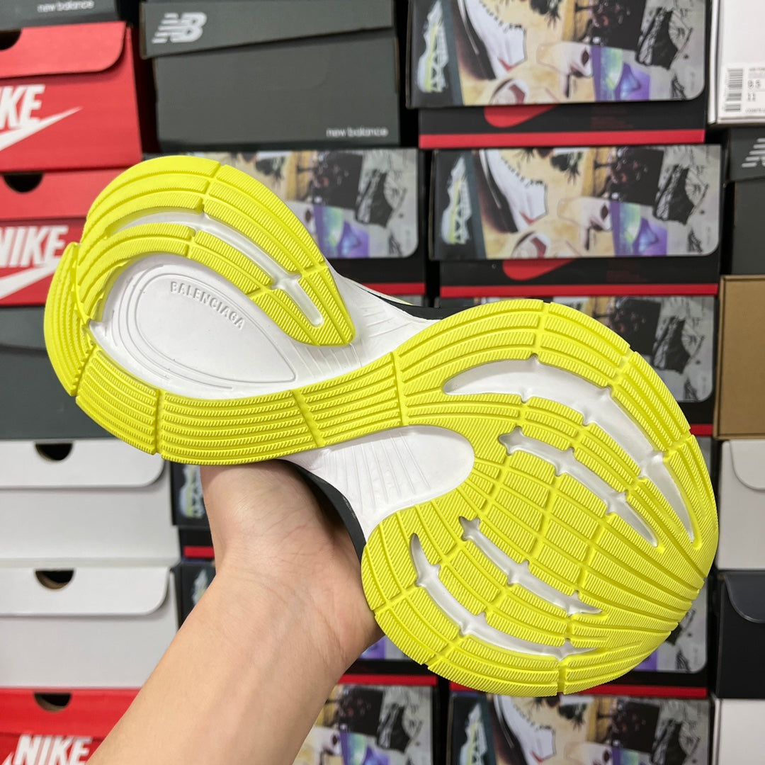 Neon yellow and white rubber outsole with tread pattern