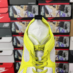 Neon yellow and white lace-up running shoe tongue and laces, interior visible