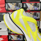 Neon yellow and white lace-up running shoe with thick white midsole and side mesh