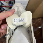 Cream sneaker size label on tongue with lace-up upper and knit lining