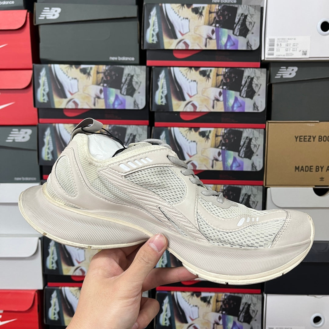 Cream mesh sneaker side profile with lace-up closure and curved sole