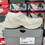 Cream lace-up sneaker with layered mesh upper and curved rubber sole