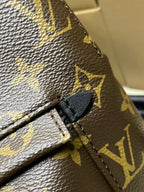 Monogram canvas backpack seam detail with black leather strap loop and stitching