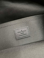 Gray fabric lining with embossed Louis Vuitton brand patch and stitching