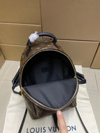 Louis Vuitton monogram mini bag with open top and black interior, front view