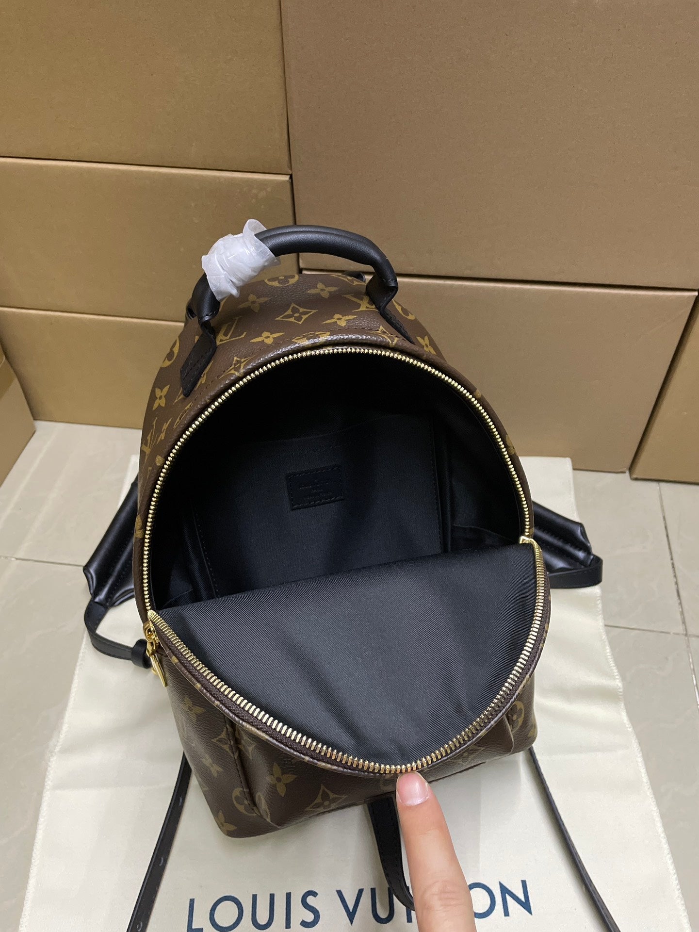 Louis Vuitton monogram mini bag with open top and black interior, front view