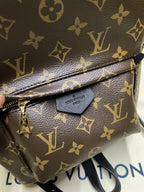 Monogram mini bag close-up with front flap, clasp hardware, and brown-gold pattern