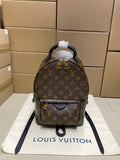 Louis Vuitton monogram backpack with top handle and black leather trim