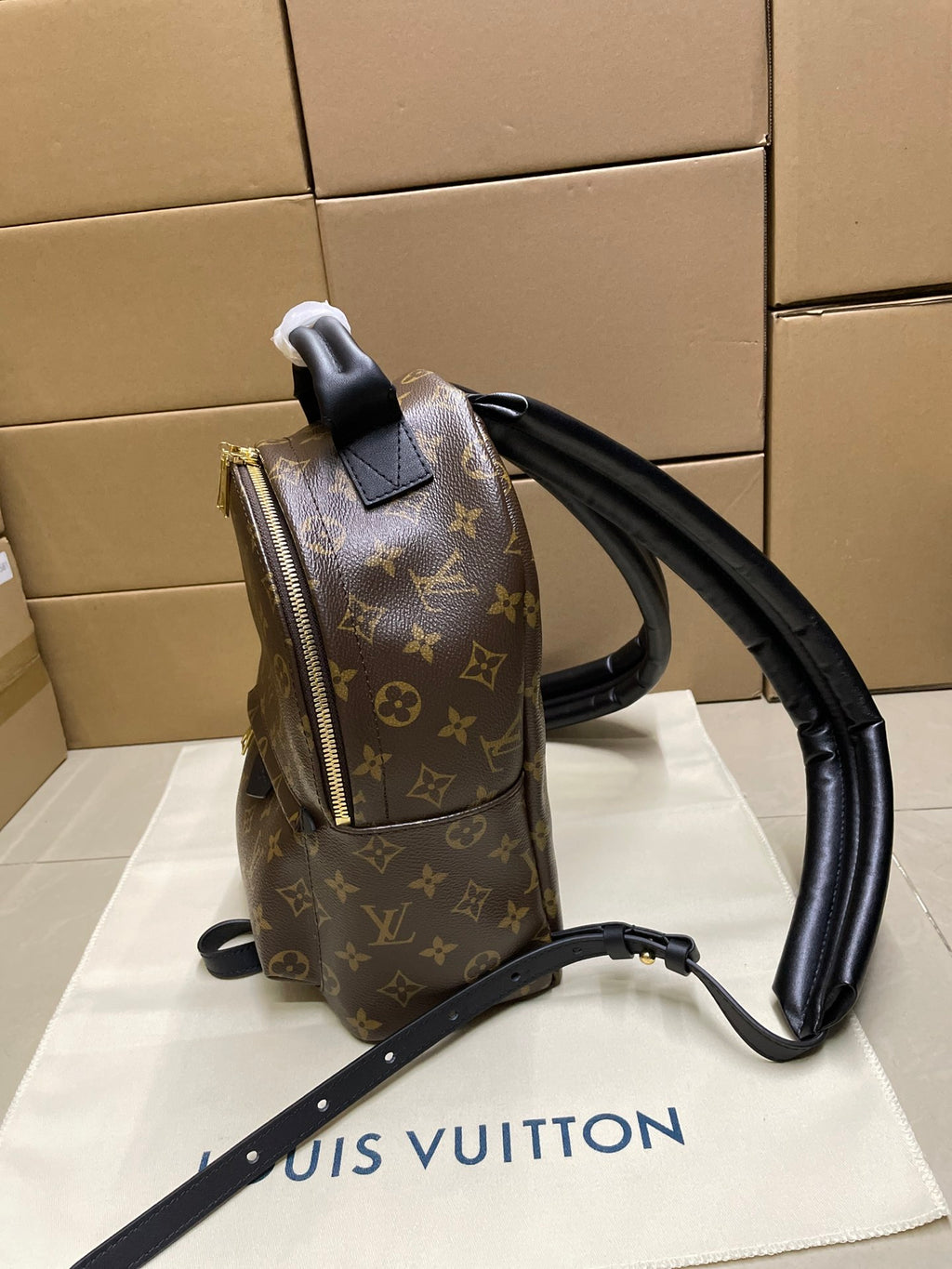 Monogram mini backpack with front zipper pocket and black top handle, dark brown