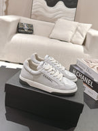 White leather low-top sneaker with lace-up front and Chanel side logo