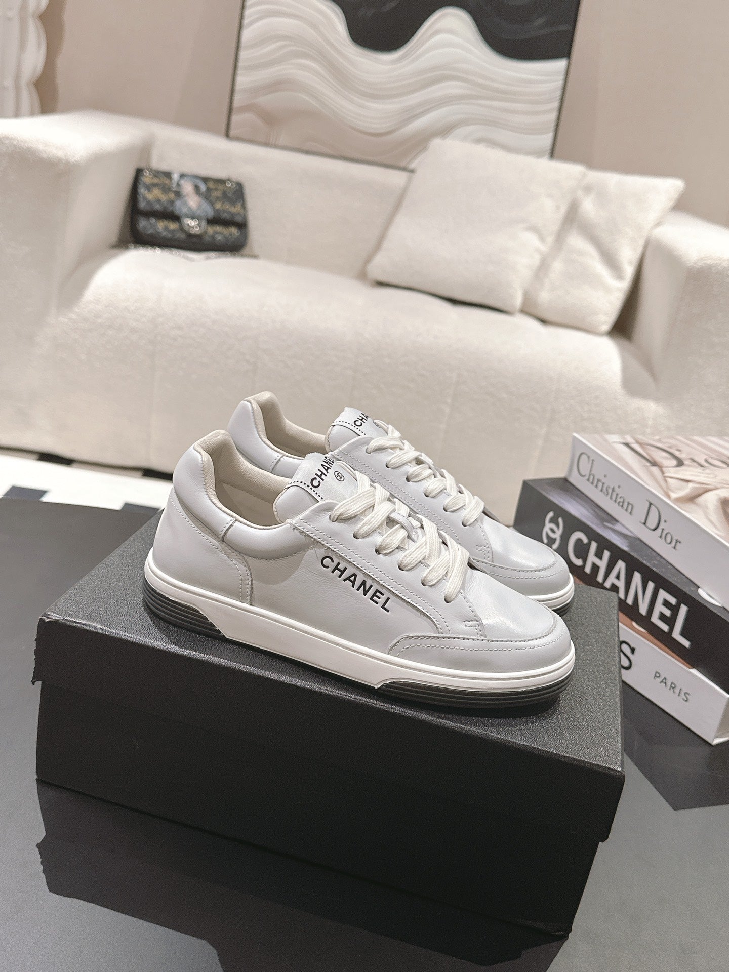 White leather low-top sneaker with lace-up front and Chanel side logo