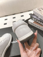 White leather sneaker heel view with cushioned collar and rubber sole