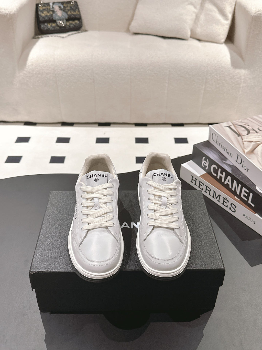 Pair of white leather low-top sneakers with lace-up vamps and Chanel logo