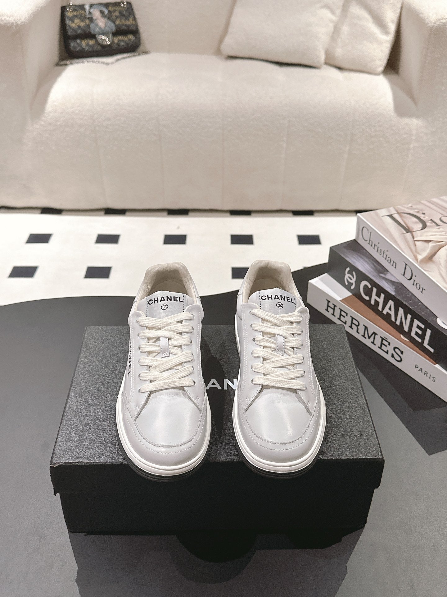 Pair of white leather low-top sneakers with lace-up vamps and Chanel logo