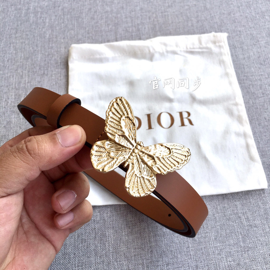 Dior brown leather belt with gold butterfly buckle, held in hand for detail.