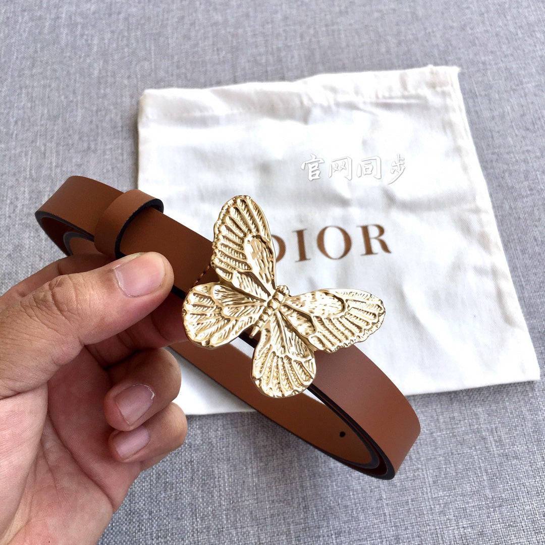 Dior brown leather belt with gold butterfly buckle, held in hand for detail.