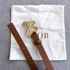 Dior brown belt with gold butterfly buckle and small adjustment holes on strap.