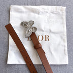 Brown leather belt with silver butterfly buckle and adjustable strap holes
