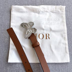 Brown leather belt with silver butterfly buckle and adjustable strap holes